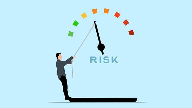 man pulling on a risk meter
